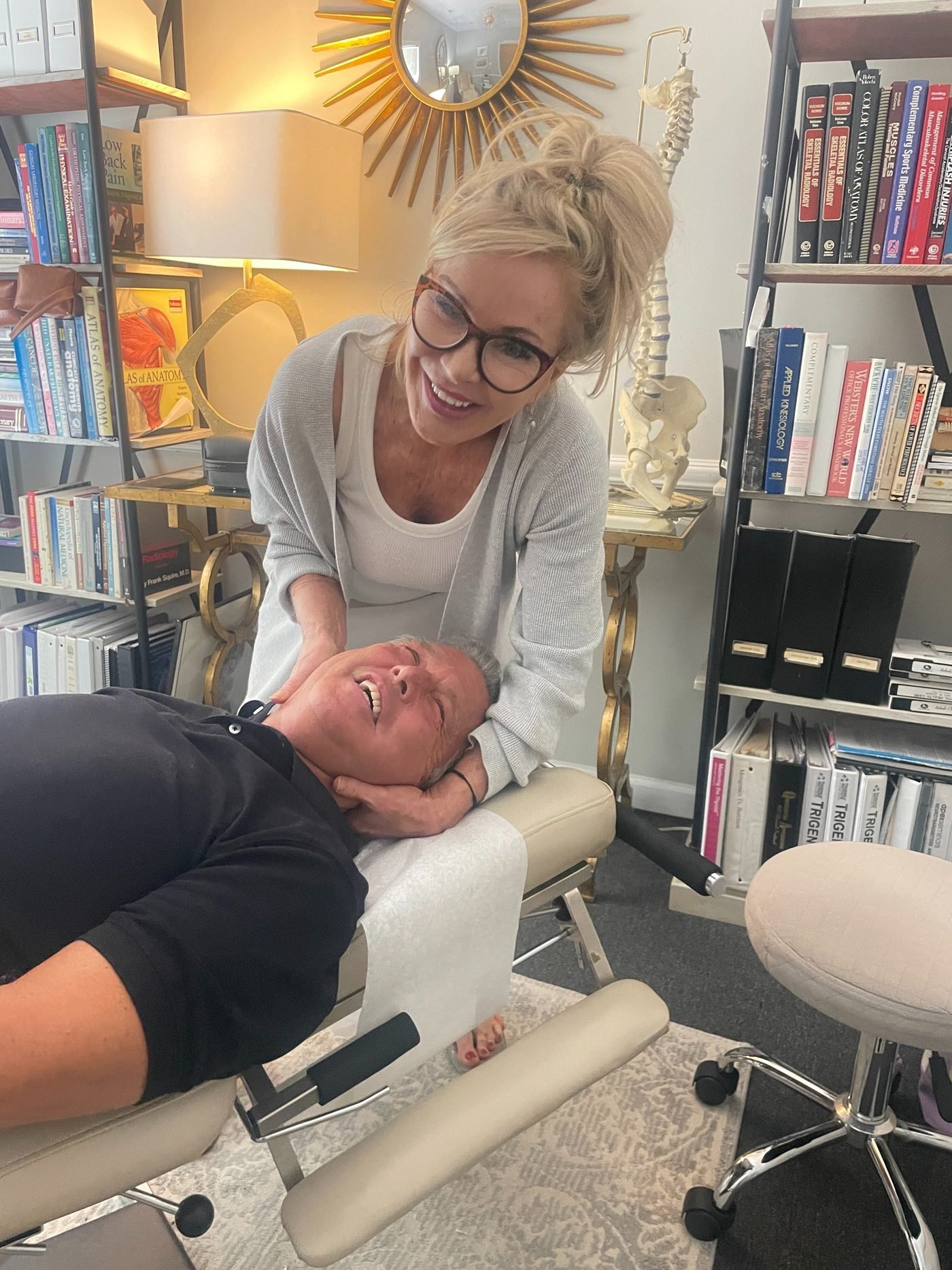 Dr. Christensen adjusting a smiling patient's neck