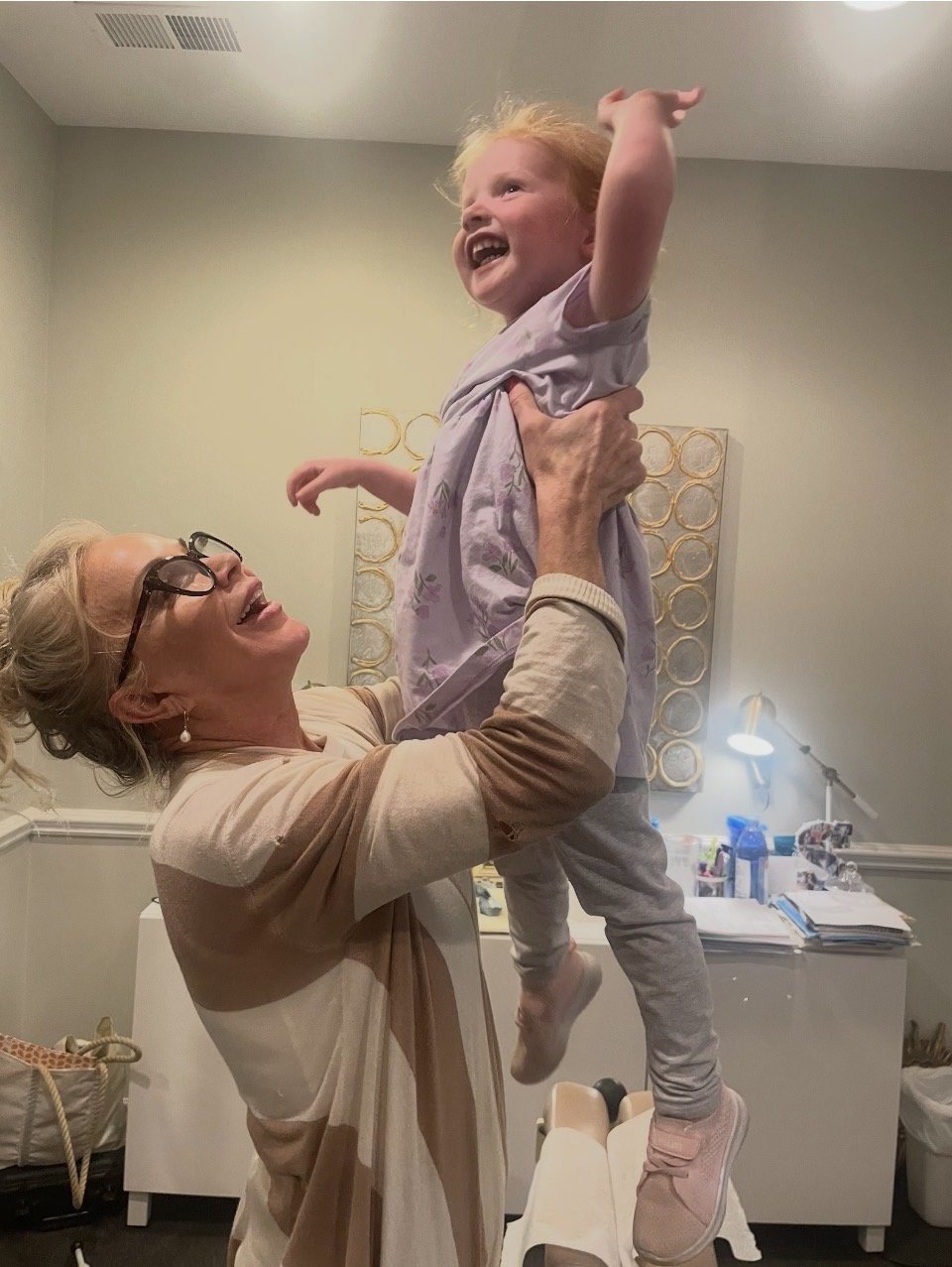 Dr. Christensen holding a happy small child