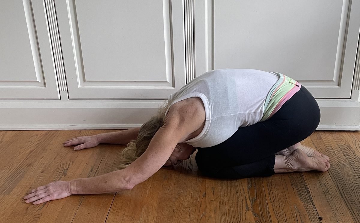 Woman demonstrating child's pose stretch