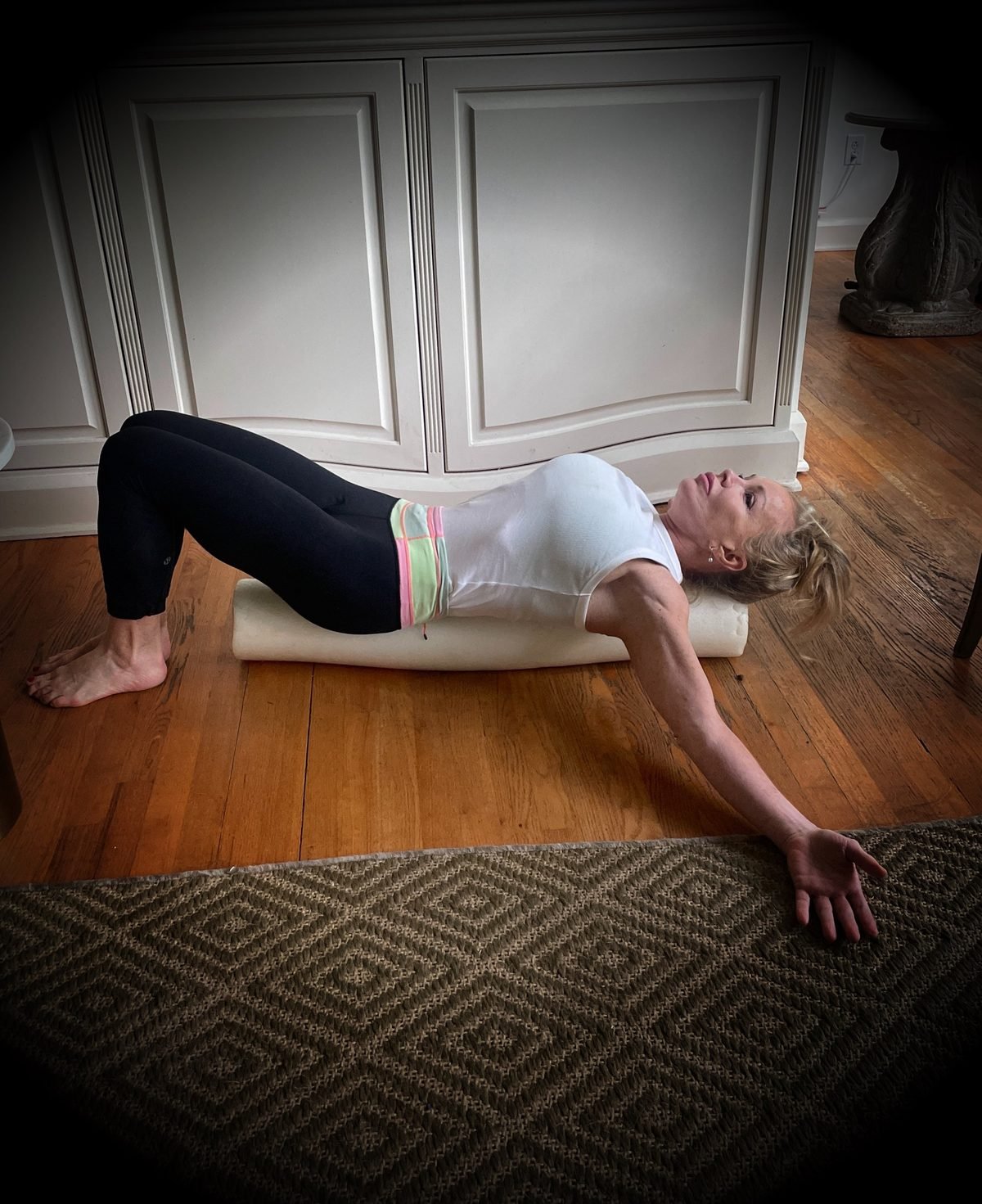 Woman stretching her back on a foam roller