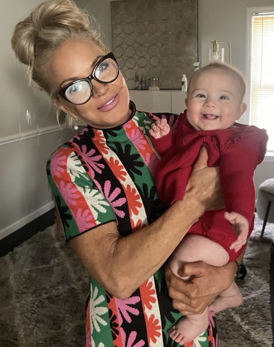Dr. Christensen holding a smiling young patient