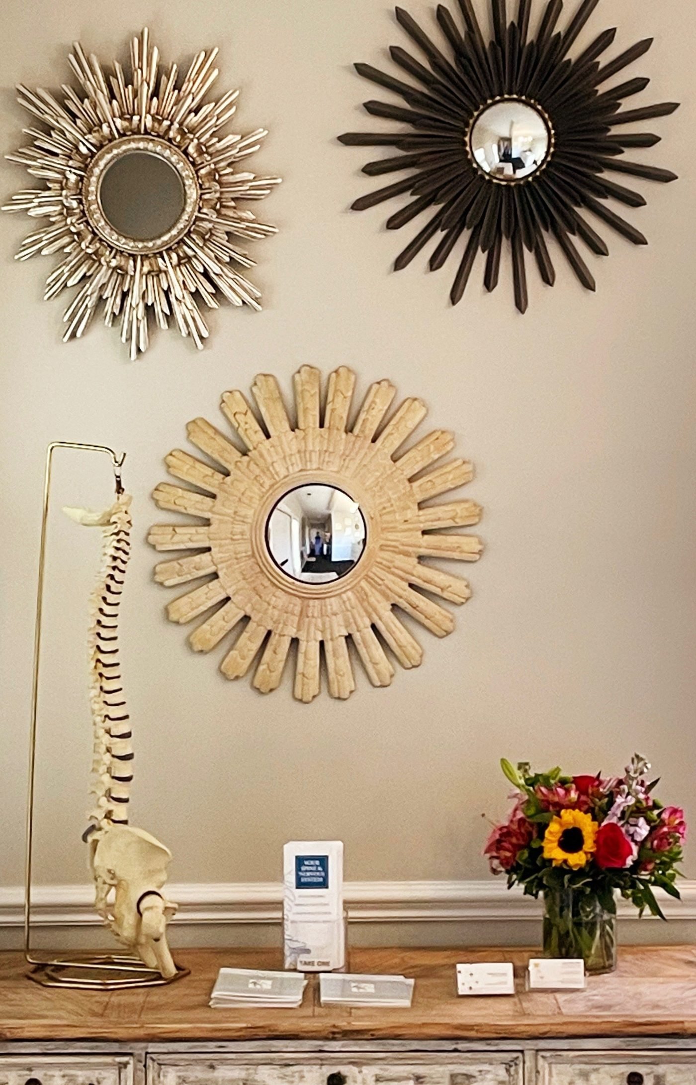 Office display with decorative mirrors and anatomy model